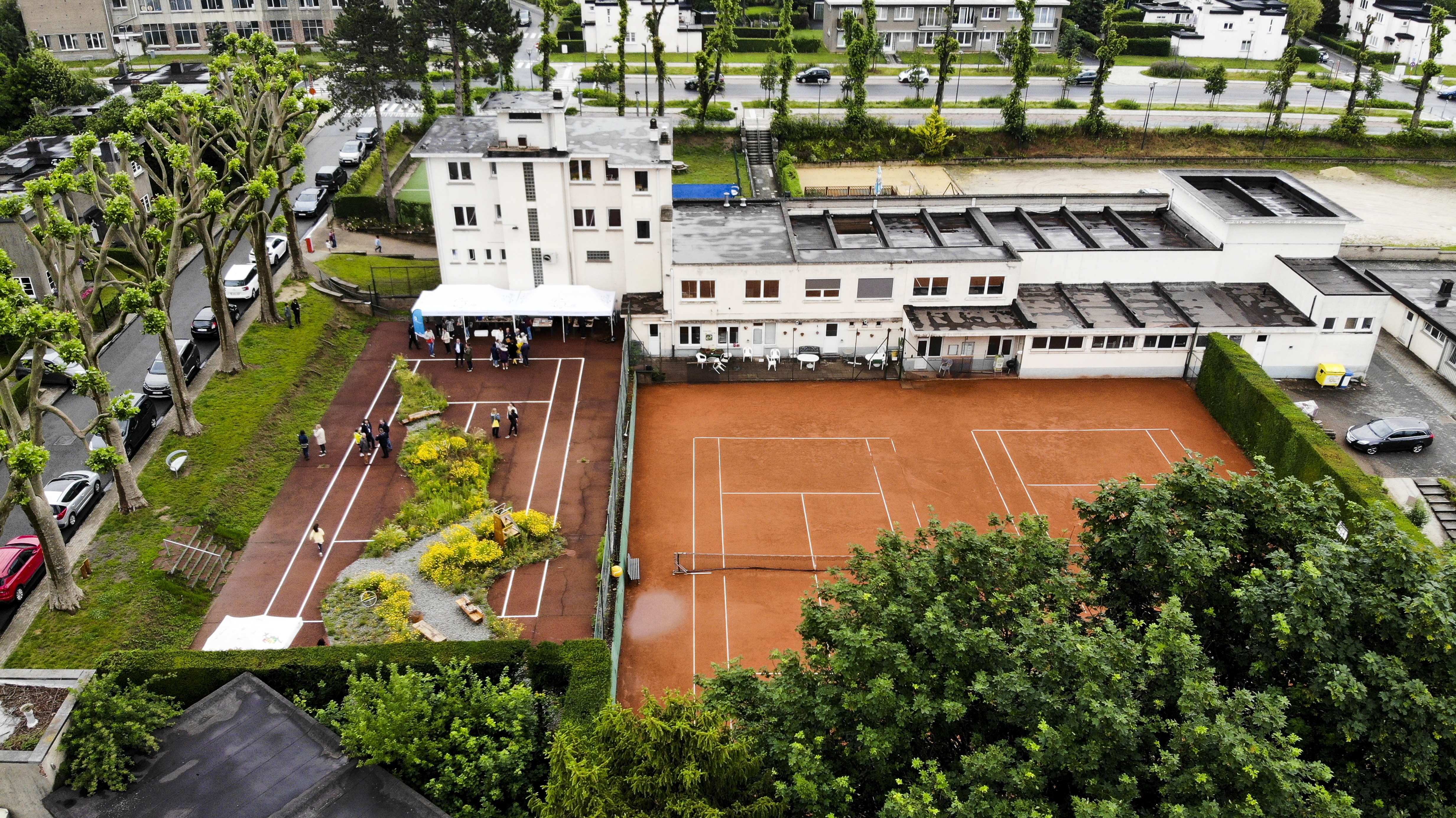 Vue aérienne sur la Faille, un écrin de verdure au sein d'un terrain de tennis abimé